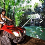 A woman embarking on an adventurous ATV ride through the dense jungle. by Chasing the Sun Vacations